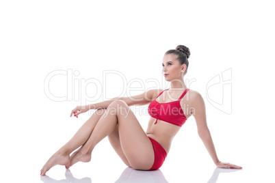 Pretty gymnast sitting, pulling her knees to chest