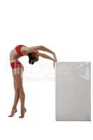 Image of flexible gymnast arched her back to cube