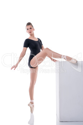 Beautiful young ballerina rehearsing in studio