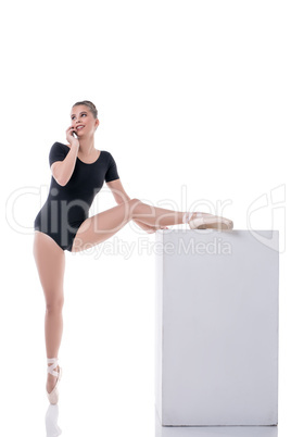 Ballet dancer talking on cellular during rehearsal