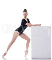 Pretty dark-haired ballerina posing while dancing