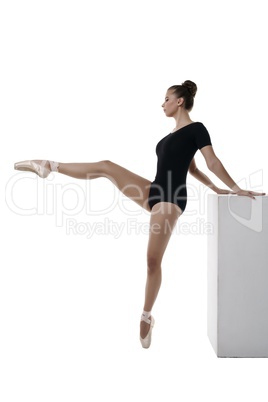Graceful ballerina rehearses, isolated on white