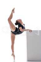 Pretty ballerina performs vertical split in dance