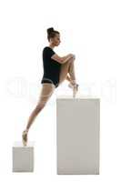 Ballerina doing stretching exercises in studio