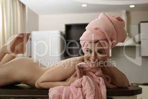 Cheerful naked woman posing lying on bar rack