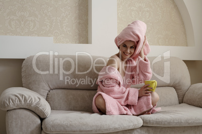 Adorable smiling woman relaxing on cozy couch