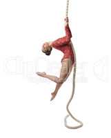 Image of graceful female gymnast hanging on rope
