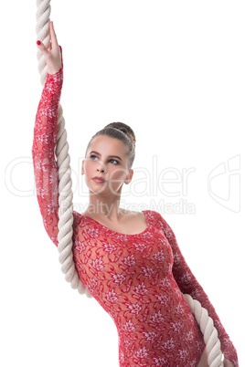 Attractive dark-haired gymnast posing with rope