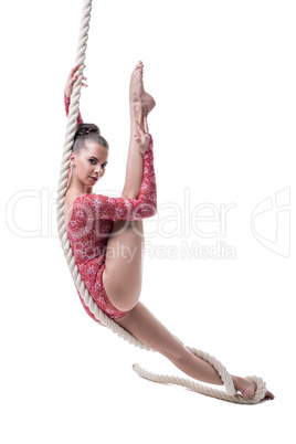 Charming barefoot girl posing hanging on rope