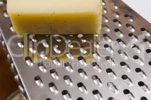 Piece of cheese and grater