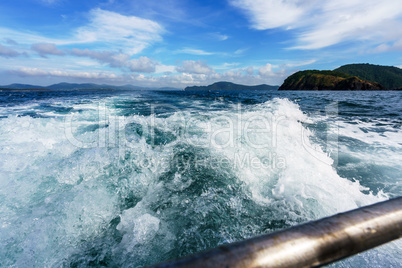 Seascape while boating. Image of sea foam on waves