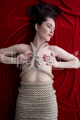 Kinbaku. Beautiful young model tied with rope