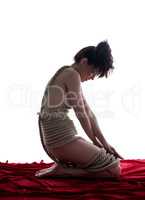 Shibari. Side view of nude girl tied with rope