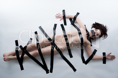 Censorship concept. Nude girl with tape on body