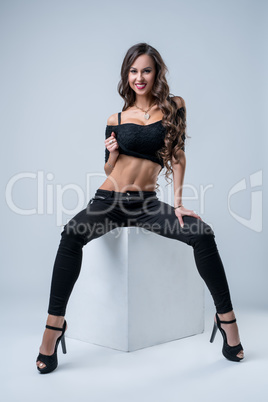 Studio shot of sporty model posing in sexy clothes