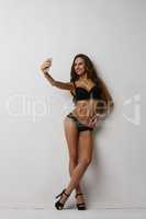 Girl, black lingerie standing in flirtatious pose