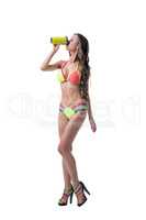 Sexy model in bright bikini drinks protein shake