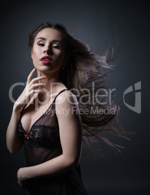 Erotica. Sensual girl posing with hair fluttering