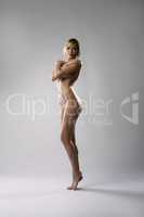 Naked blonde with perfect body posing at camera