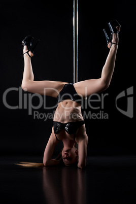 Image of pole dancer doing acrobatic handstand