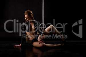 Studio image of hot pole dancer in erotic clothes