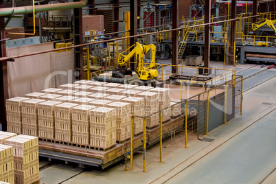 Manufactured bricks stacked on pallets in workshop