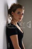 Studio photo of nice young brunette in black dress