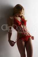 Erotica. Blonde model touts red lace bodysuit
