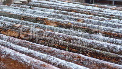 Image of snow-covered logs at sawmill