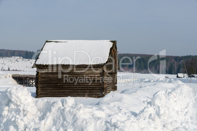 Winter time. Image of log house in village