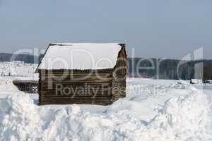 Winter time. Image of log house in village