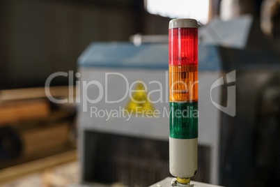 At sawmill. Image of tri-color LED on machine