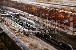 At sawmill. Close-up of wood and chain