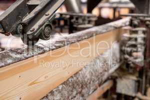 At sawmill. Image of cut wood using machine