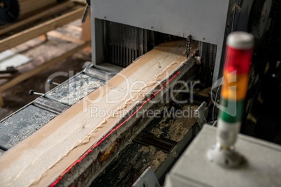 At sawmill. Image of sawing wood with laser marks