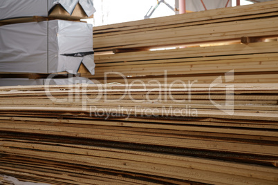 Image of wooden boards piled at sawmill