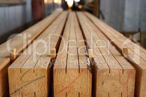 Image of wooden beams with cuts and color marks