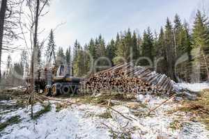 Image of truck loading logs in winter forest