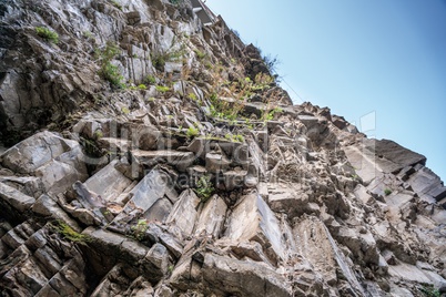 Bottom view of rocks on blue sky background