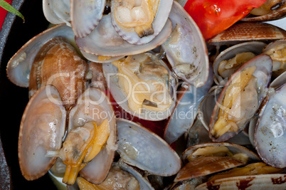 fresh clams on an iron skillet