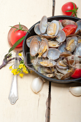 fresh clams on an iron skillet