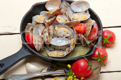 fresh clams on an iron skillet