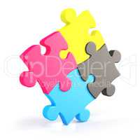 Four assembling colorful puzzle pieces in cmyk