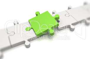 Focus on a green puzzle pieces