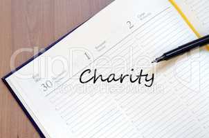 Charity write on notebook