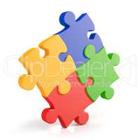 Four assembling colorful puzzle pieces