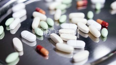 medicaments and Vitamins turning on silver tray