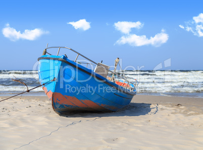 Blue fishing boat on the beach