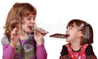 two little girls eating chocolate