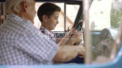 1-Grandfather Telling History Of Vintage Car To Grandson